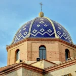 Stunning dome of the Church of Our Lady of Consuelo in Altea, Spain under a clear blue sky.